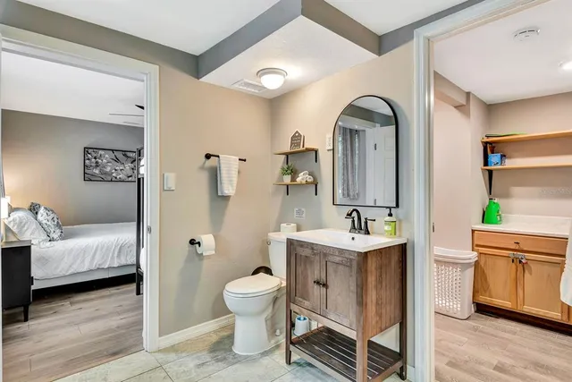 a bathroom with a sink toilet and mirror