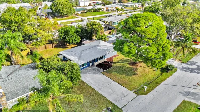 an aerial view of a house with a yard