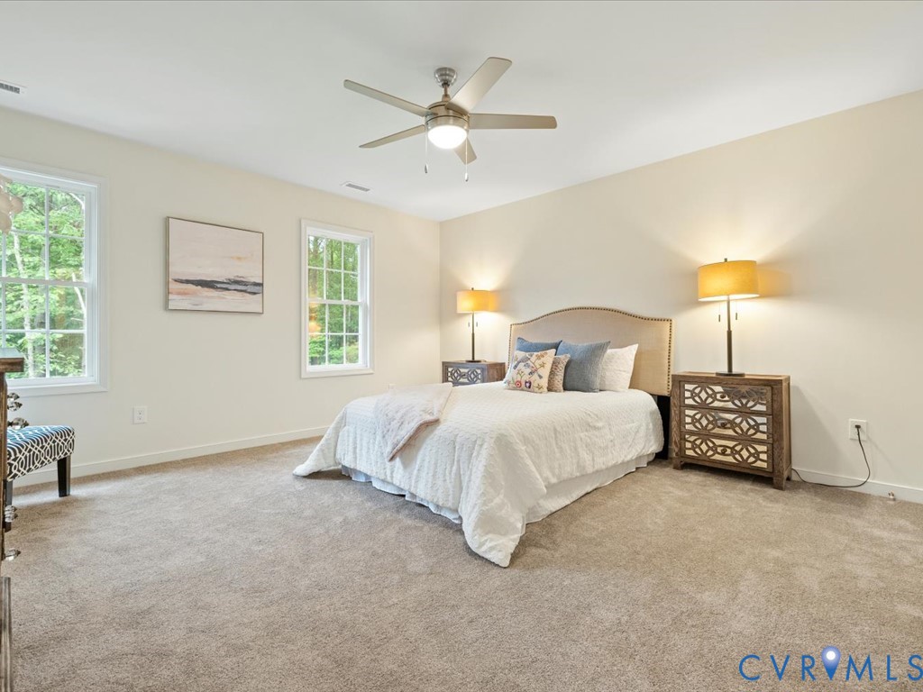 160 Ashburn Road Cumberland, VA 23040 - Photo 31 of 45 a spacious bedroom with a bed and a ceiling fan