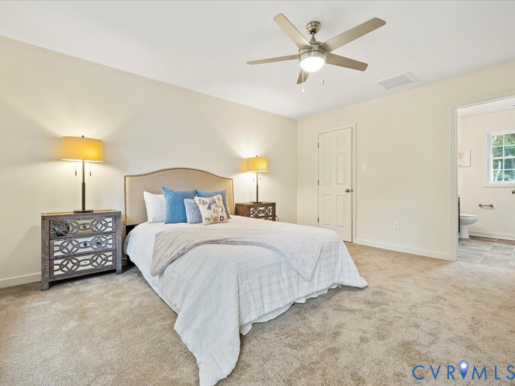160 Ashburn Road Cumberland, VA 23040 - Photo 32 of 45 a bedroom with a bed and a chandelier