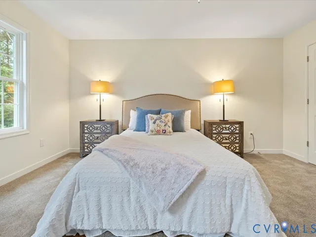 a bedroom with a bed and a lamp