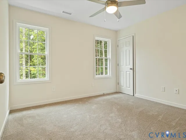 an empty room with windows and closet