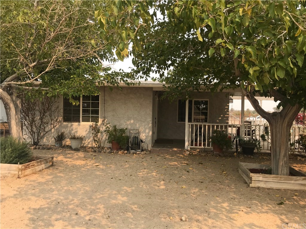55878 Tanager Road Yucca Valley, CA 92284 - Photo 1 of 1 a front view of a house with a yard