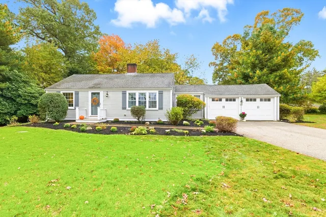a front view of a house with yard patio and swimming pool