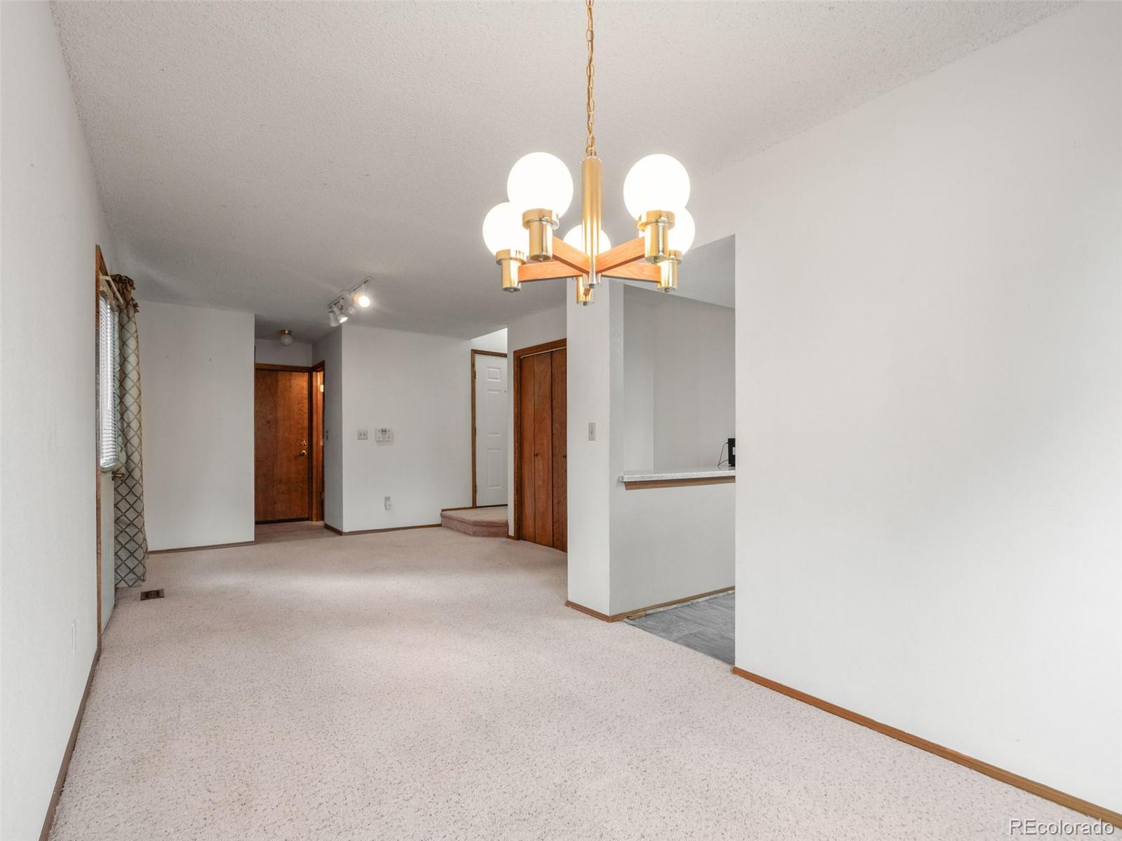 10016 Raritan Way Thornton, CO 80260 - Photo 11 of 43 a view of a chandelier in a room