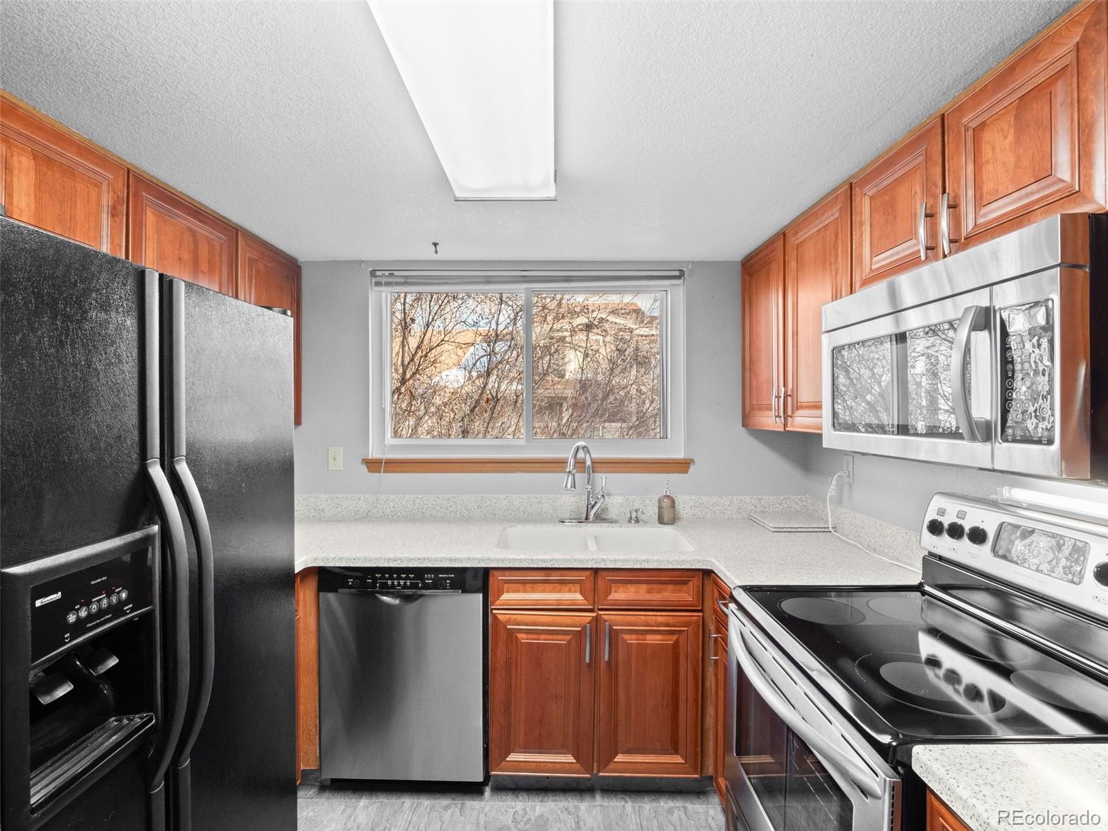 10016 Raritan Way Thornton, CO 80260 - Photo 15 of 43 a kitchen with stainless steel appliances granite countertop a refrigerator and a stove