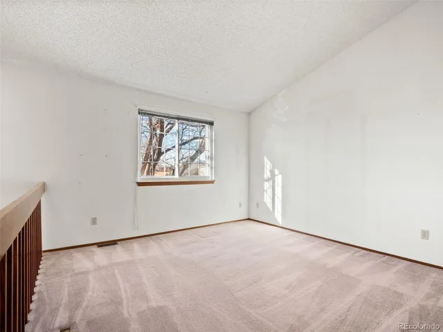 an empty room with windows and closet