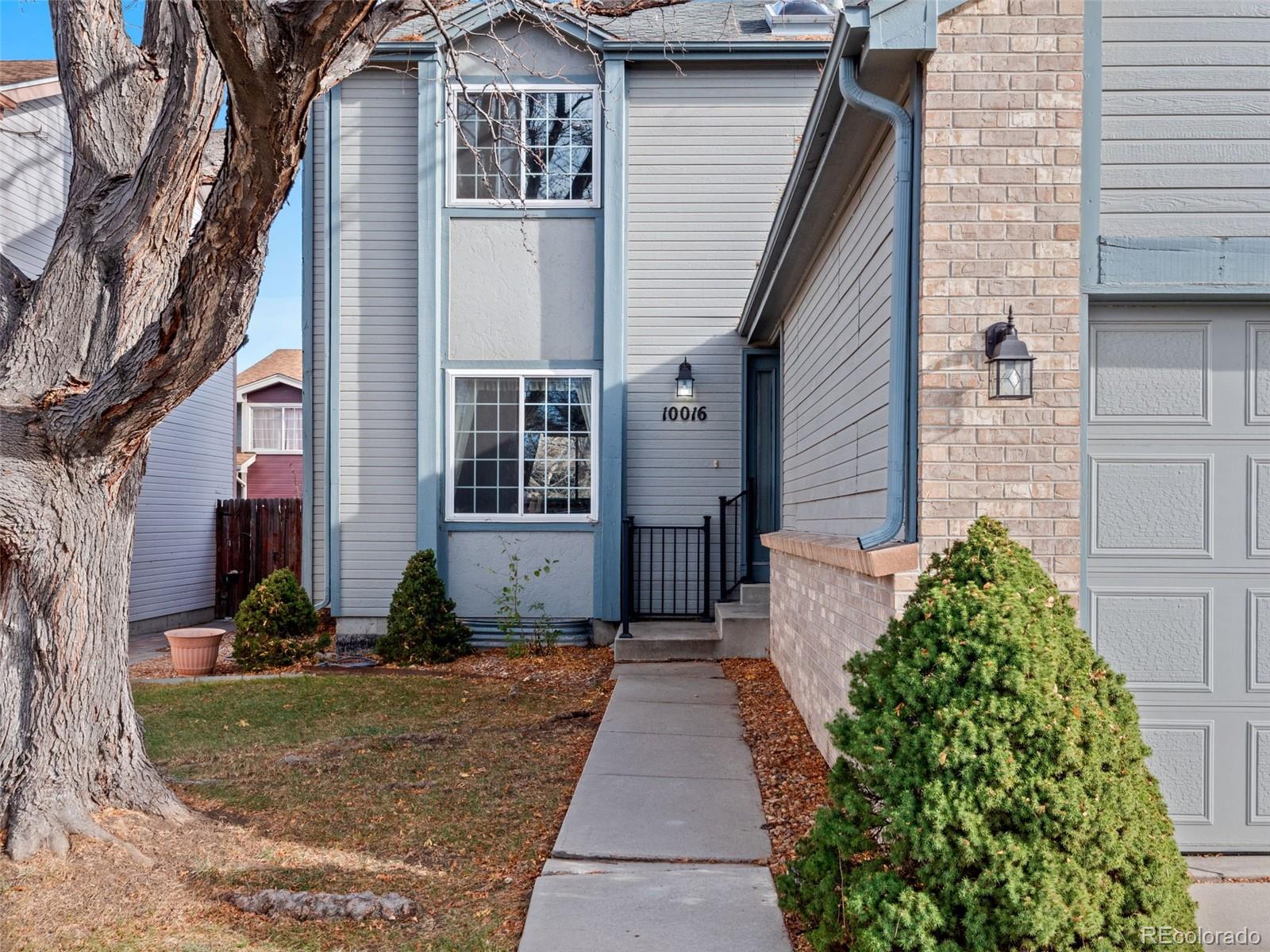 10016 Raritan Way Thornton, CO 80260 - Photo 2 of 43 a front view of a house with garden