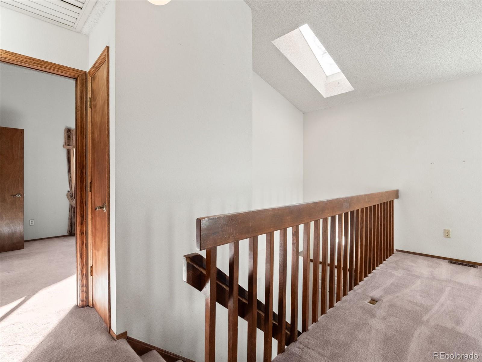10016 Raritan Way Thornton, CO 80260 - Photo 26 of 43 a view of hallway with stairs