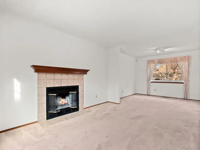 a view of an empty room with a fireplace