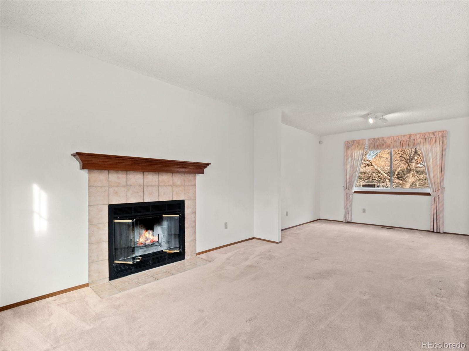 10016 Raritan Way Thornton, CO 80260 - Photo 4 of 43 a view of an empty room with a fireplace