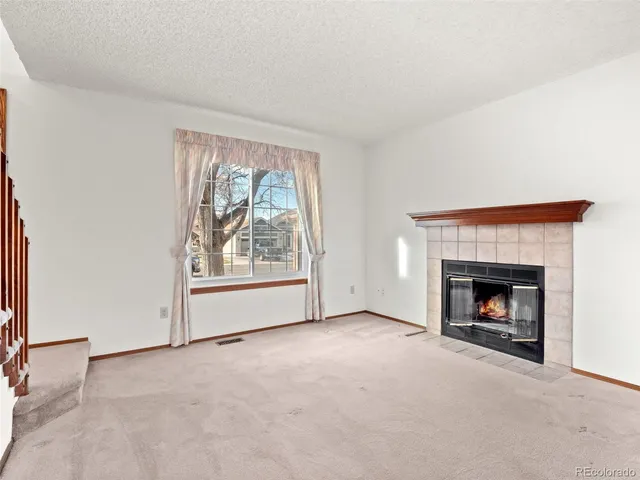 a view of empty room with a fireplace