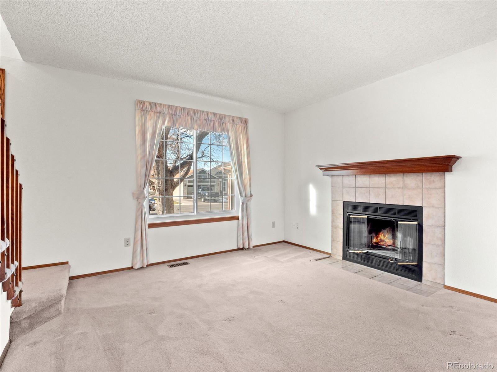 10016 Raritan Way Thornton, CO 80260 - Photo 5 of 43 a view of empty room with a fireplace