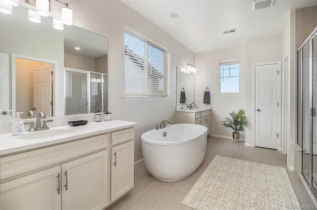 a bathroom with a shower a toilet and a sink