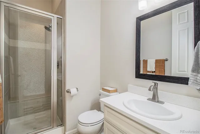 a view of a room with a stylish ceiling fan and entryway