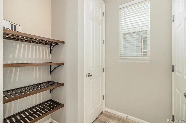 a front view of a house with a garden and plants