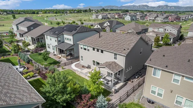 an aerial view of houses with a lake