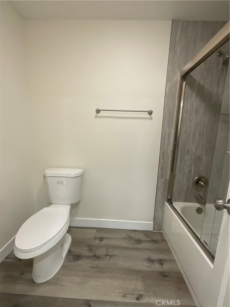 16862 Green, Unit 2 Huntington Beach, CA 92649 - Photo 12 of 13 a white toilet sitting next to a bath tub and a shower