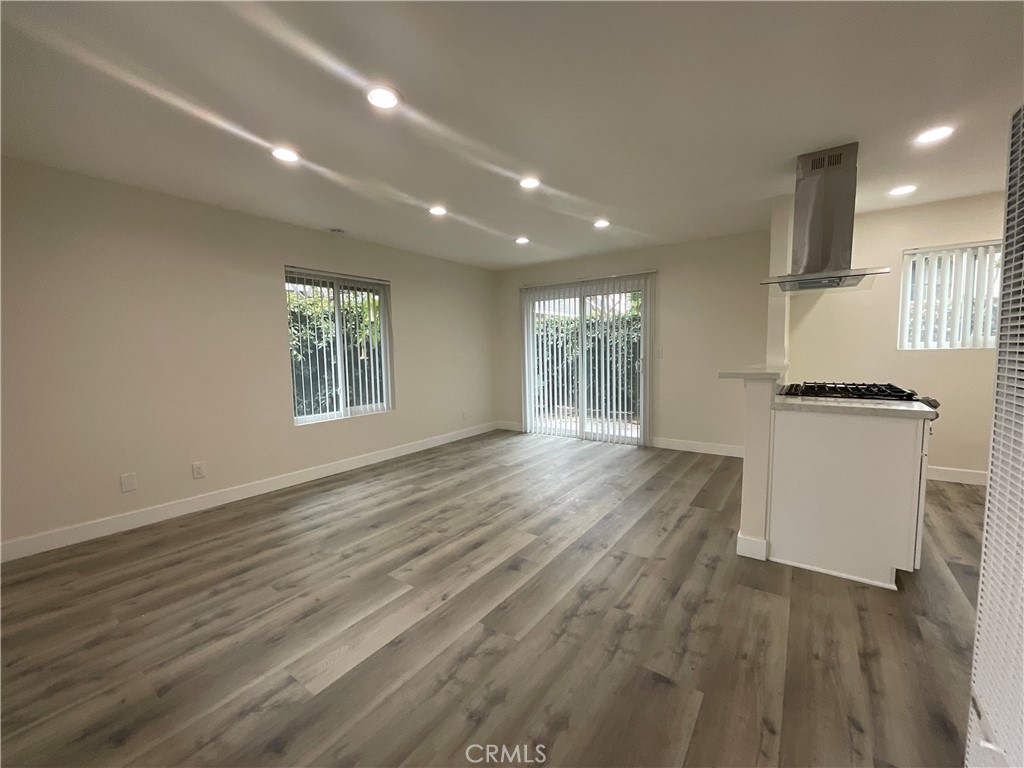 16862 Green, Unit 2 Huntington Beach, CA 92649 - Photo 2 of 13 a view of an empty room with wooden floor and a window