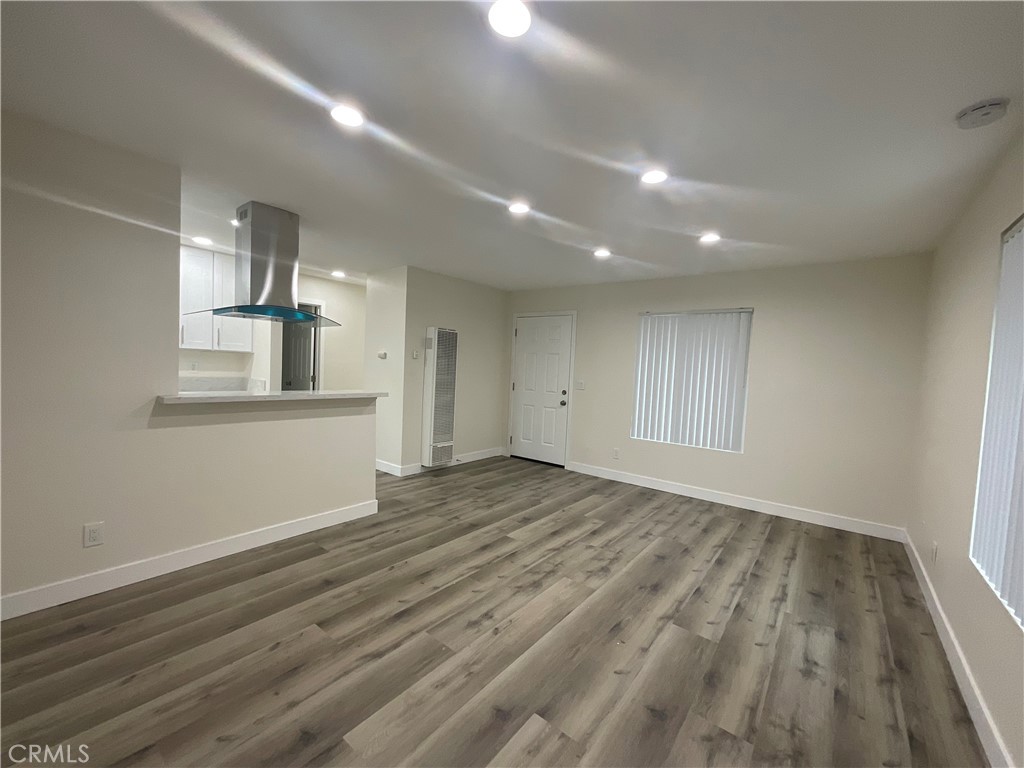 16862 Green, Unit 2 Huntington Beach, CA 92649 - Photo 5 of 13 wooden floor in an empty room with a window