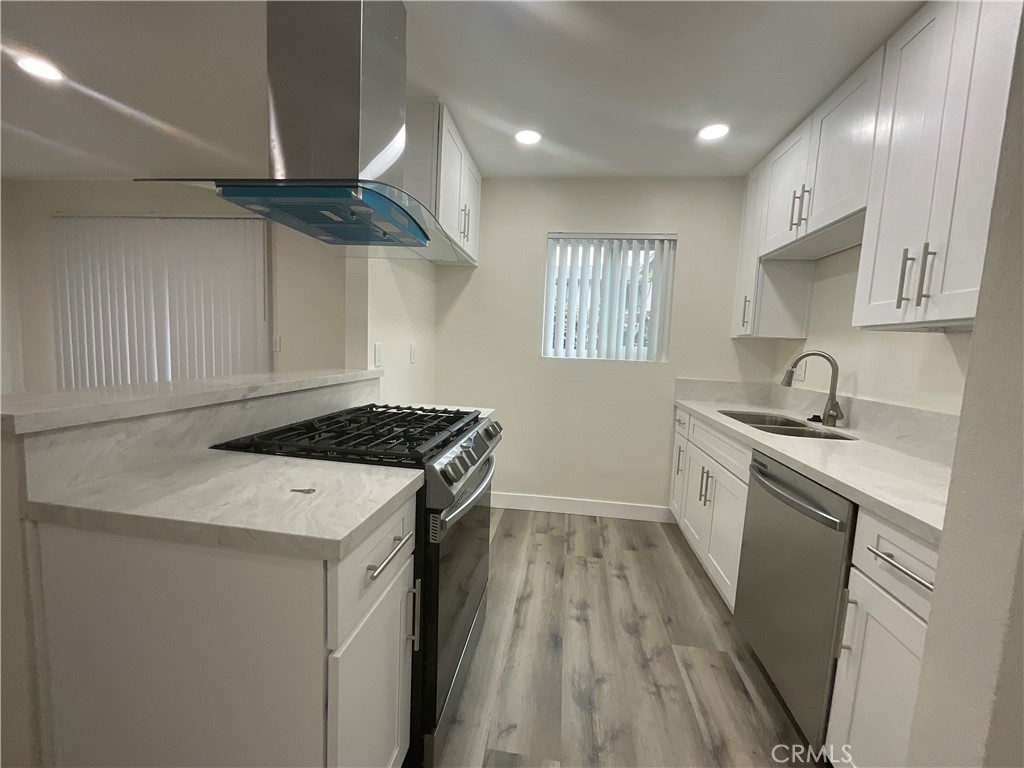 16862 Green, Unit 2 Huntington Beach, CA 92649 - Photo 6 of 13 a kitchen that has a sink a stove and a window