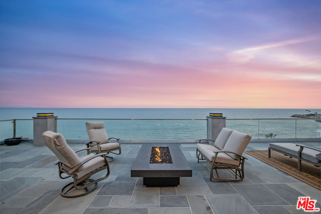 18074 Coastline Drive Malibu, CA 90265 - Photo 1 of 33 a terrace with outdoor seating and city view