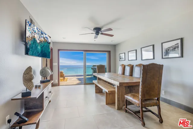 a living room with stainless steel appliances granite countertop furniture and a kitchen view