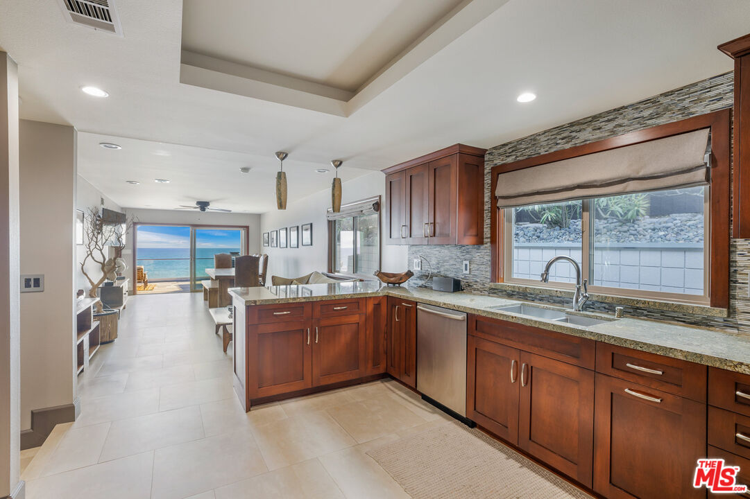 18074 Coastline Drive Malibu, CA 90265 - Photo 18 of 33 a large kitchen with stainless steel appliances granite countertop a lot of counter space and a sink