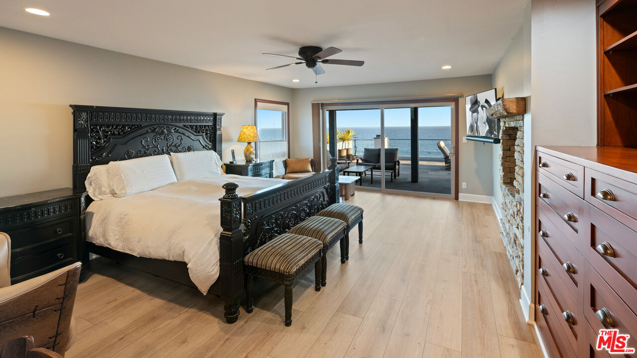 18074 Coastline Drive Malibu, CA 90265 - Photo 21 of 33 a bed room with a bed and a couch