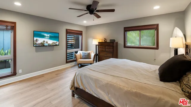 a bathroom with a sink a toilet a mirror and shower