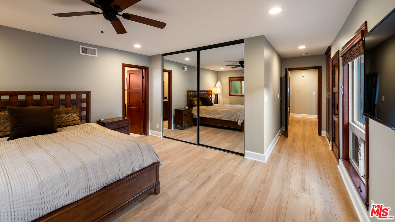 18074 Coastline Drive Malibu, CA 90265 - Photo 26 of 33 a bedroom with a bed and a large mirror