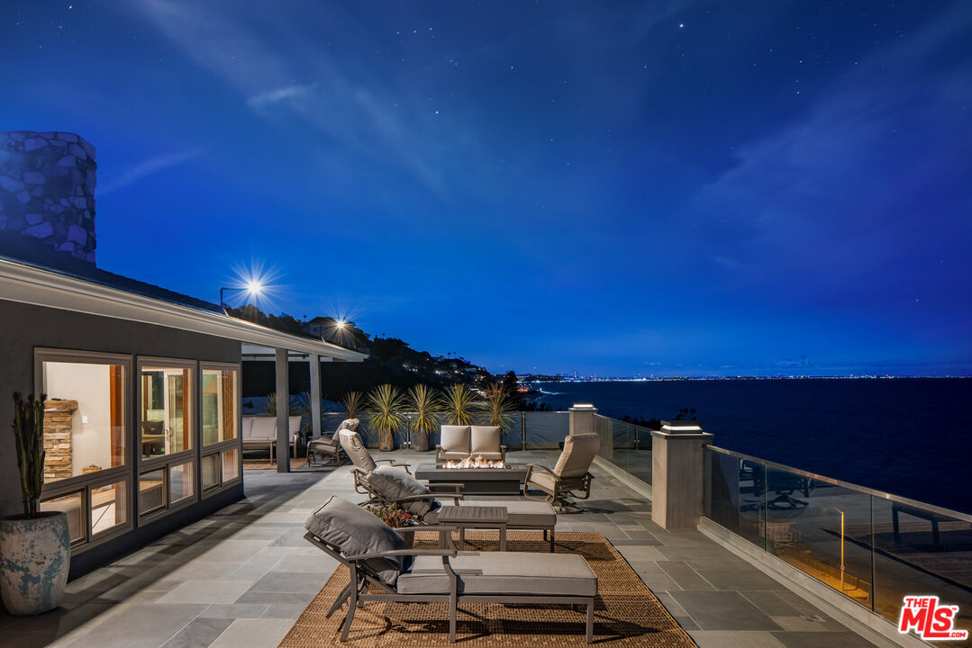 18074 Coastline Drive Malibu, CA 90265 - Photo 5 of 33 a view of a patio with swimming pool and sitting area