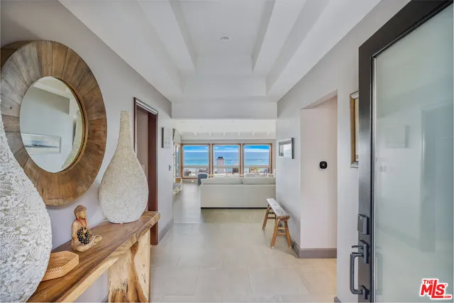 a living room with furniture large window and a fireplace