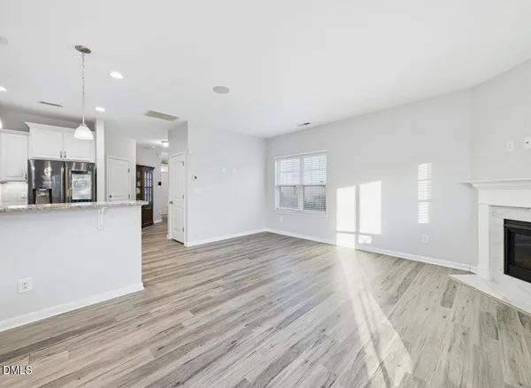 a view of an entryway and livingroom with wooden floor