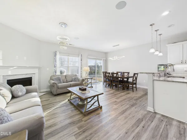 a living room with furniture and kitchen view