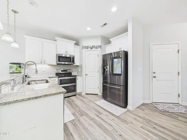 a kitchen with granite countertop a stove and a sink