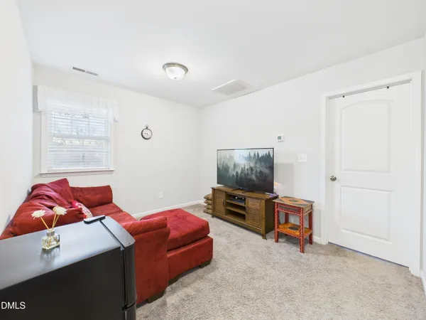a bedroom with a bed and a large window with the outer view