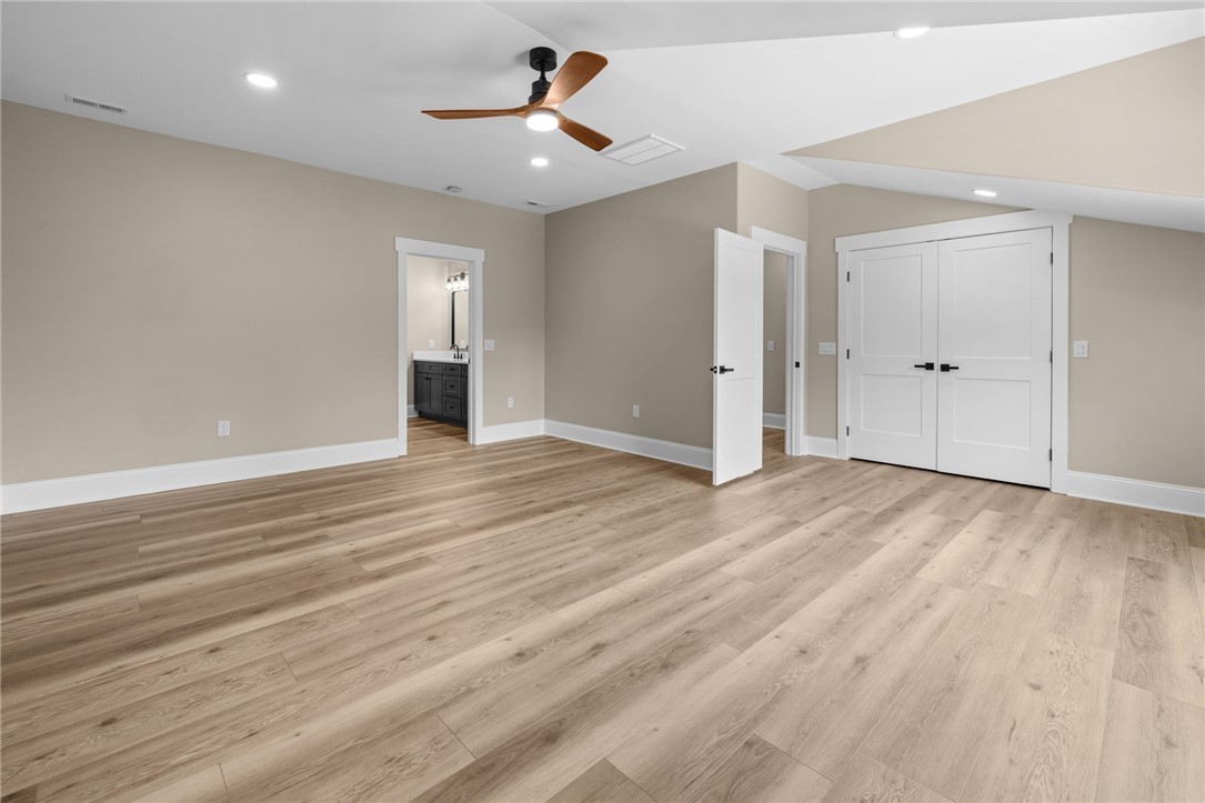 147 McAlister Road West Union, SC 29696 - Photo 35 of 50 Warm wood flooring and vaulted ceilings define this peaceful bedroom retreat.