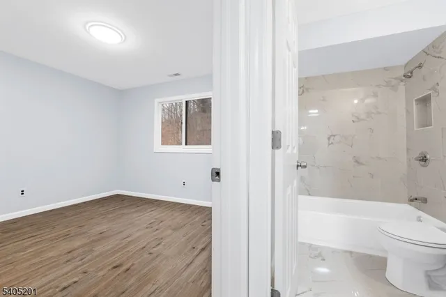 a bathroom with a toilet a sink and bathtub