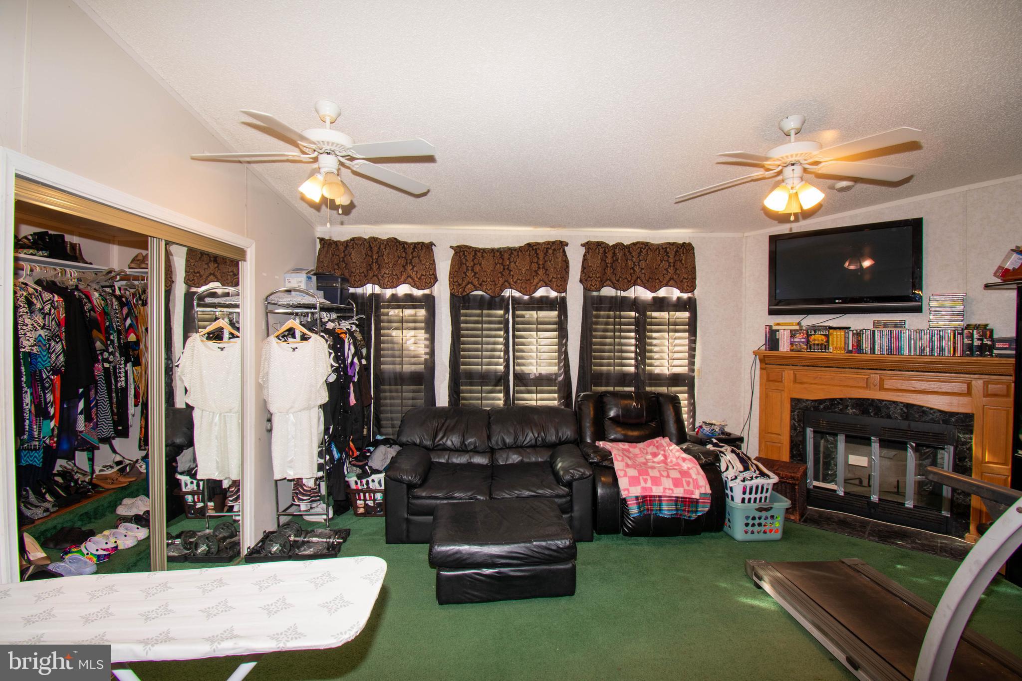 8791 Menokin Road Montross, VA 22520 - Photo 22 of 37 a living room with fireplace furniture and a flat screen tv