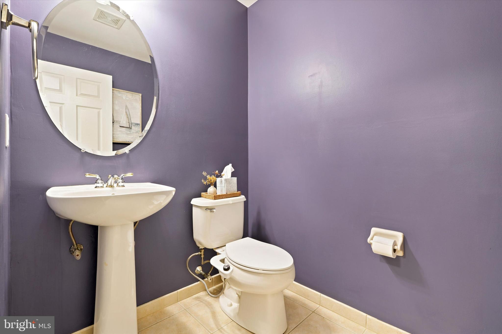 215 Flagstone Road, Unit 1 Chester Springs, PA 19425 - Photo 9 of 33 a bathroom with a toilet a sink and mirror