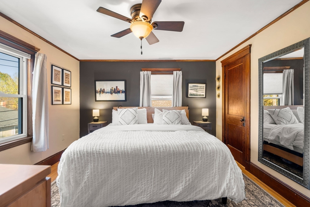 11 Pickman Road Salem, MA 01970 - Photo 19 of 40 a bedroom with a large bed and a chandelier