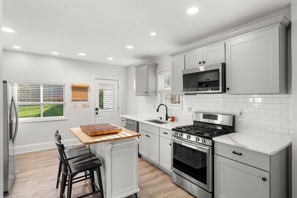 11 Pickman Road Salem, MA 01970 - Photo 4 of 40 a kitchen with a stove a sink and a microwave