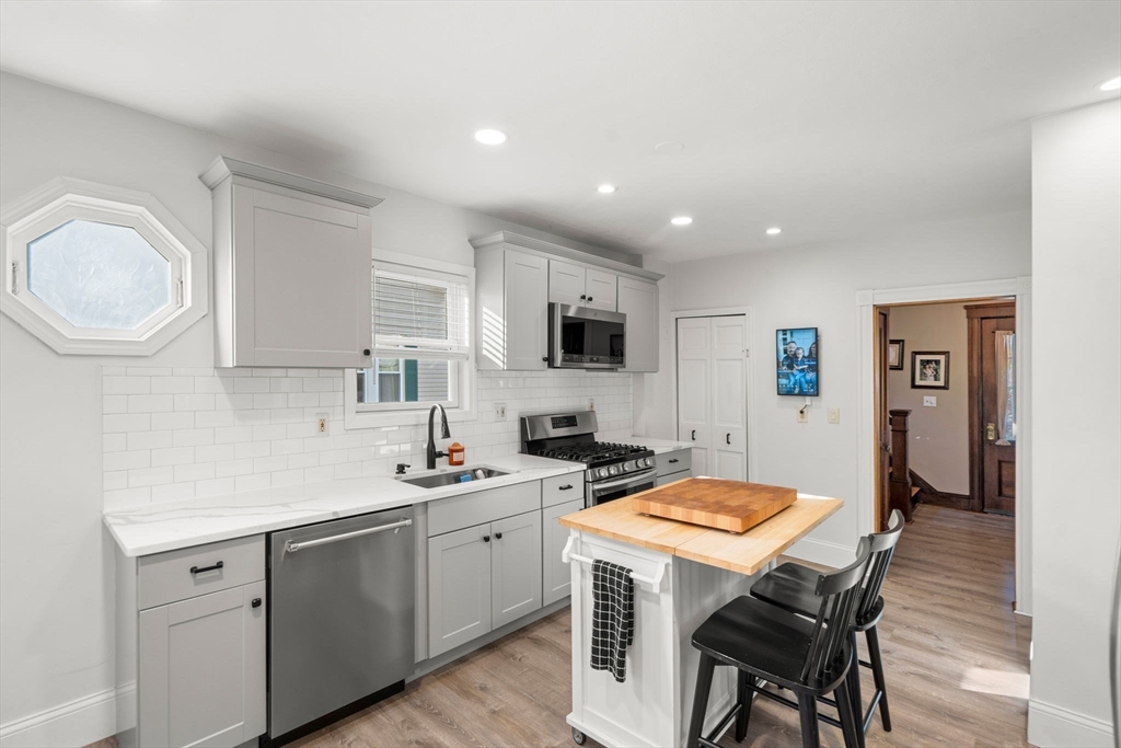 11 Pickman Road Salem, MA 01970 - Photo 7 of 40 a kitchen with a sink a stove a refrigerator cabinets and dining table