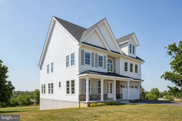 a view of a large white house with a swimming pool
