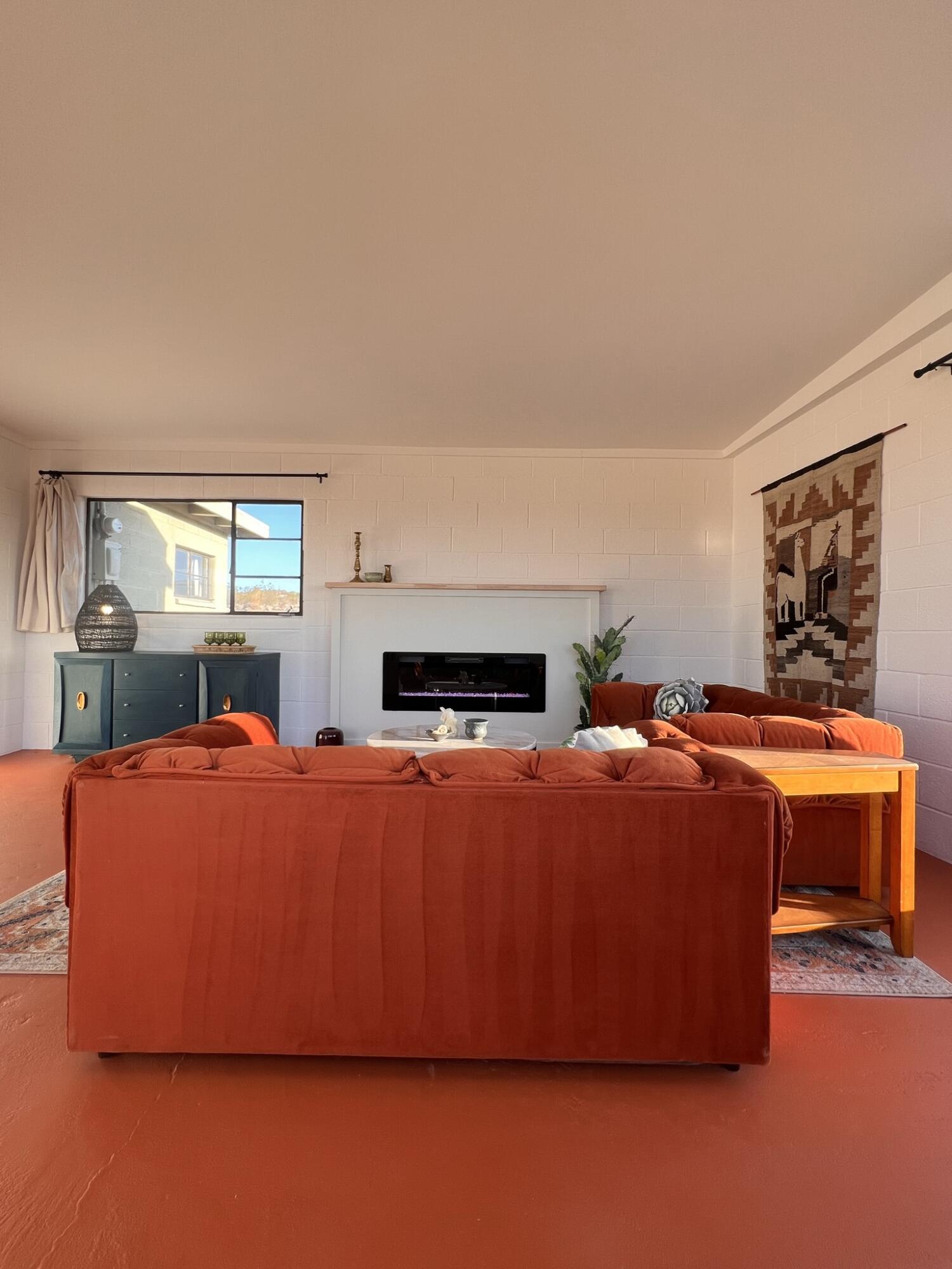 52079 Ocotillo Road Johnson Valley, CA 92285 - Photo 25 of 51 a living room with furniture a fireplace and a flat screen tv