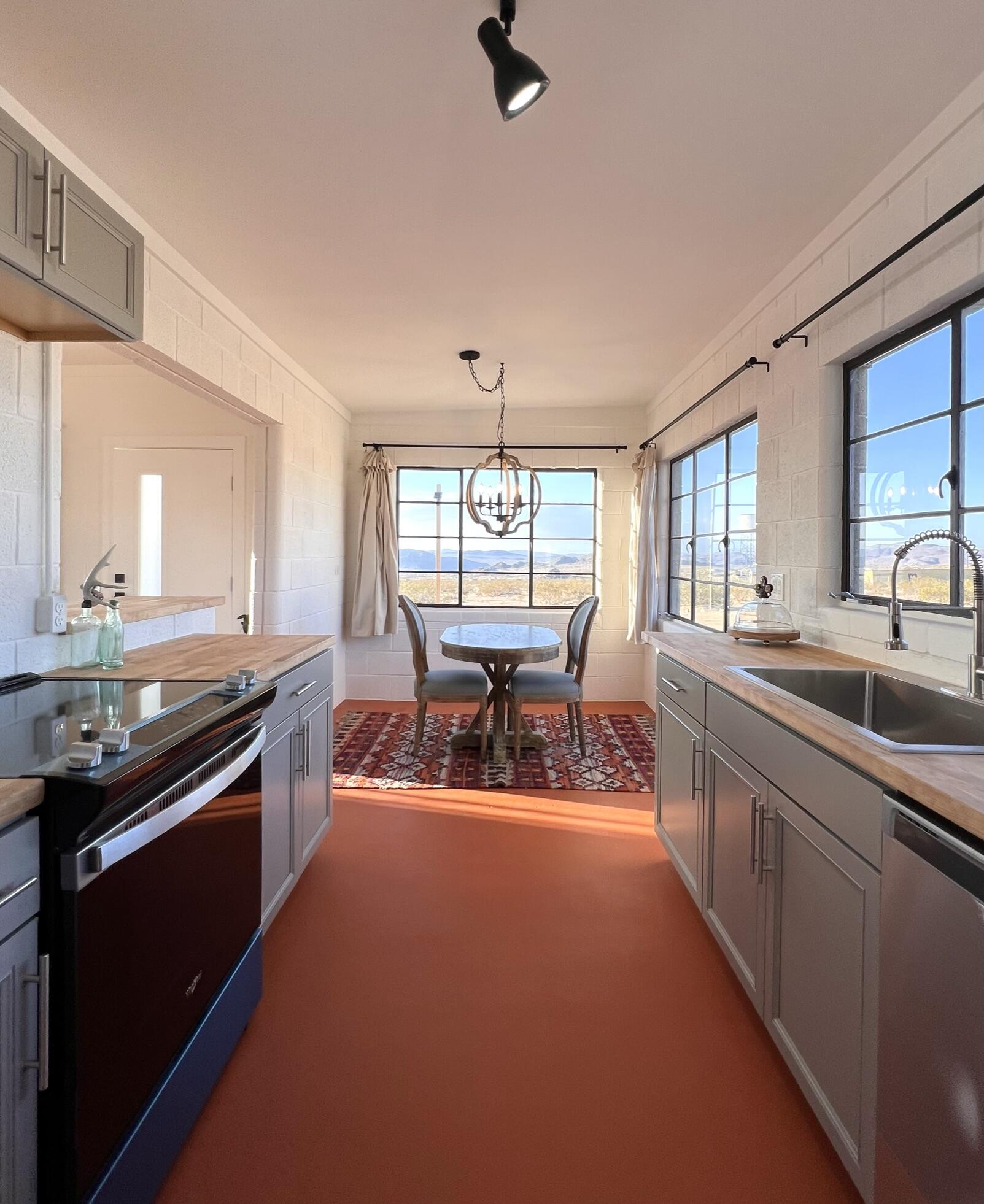 52079 Ocotillo Road Johnson Valley, CA 92285 - Photo 26 of 51 a large kitchen with stainless steel appliances granite countertop a sink and a stove