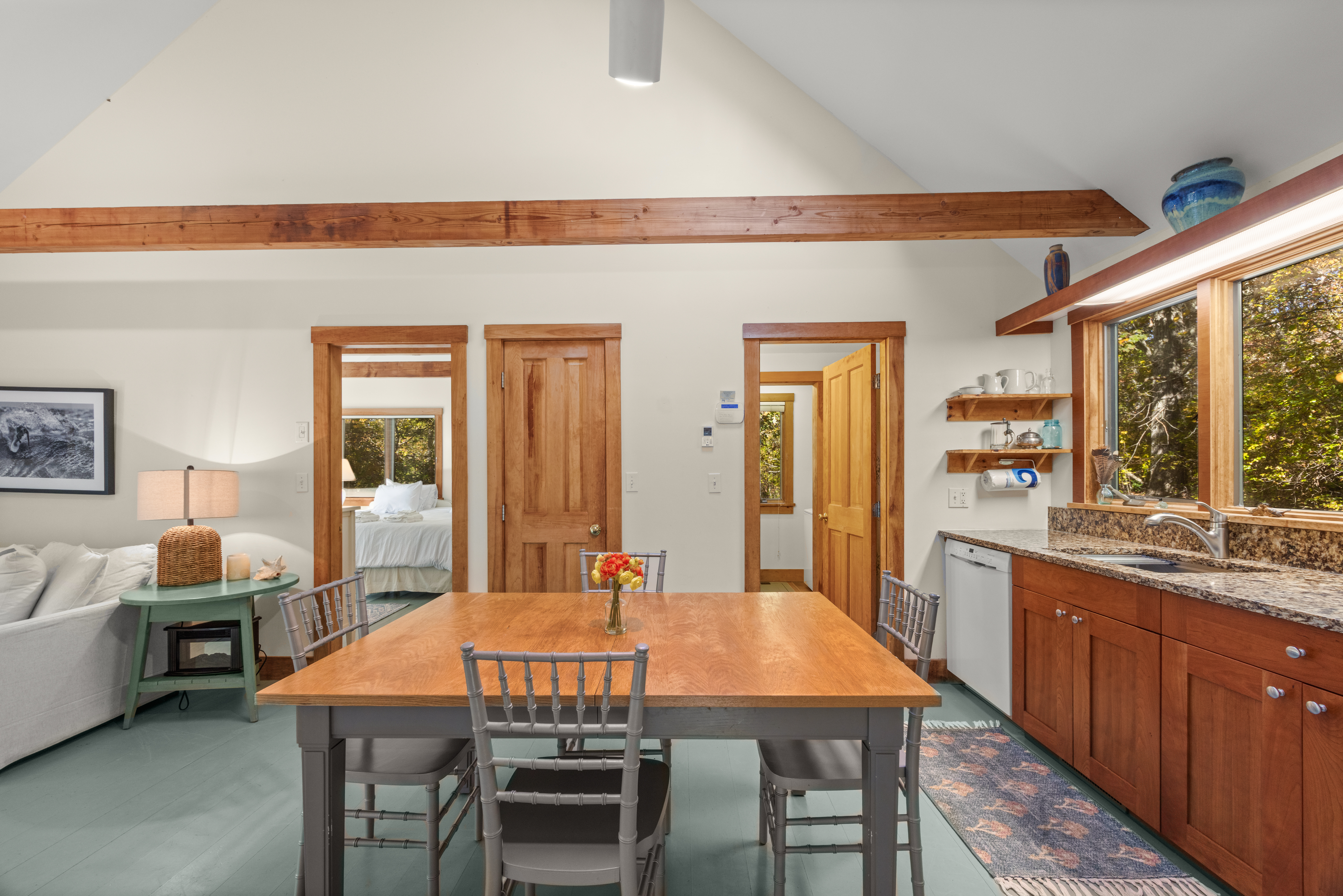 46 Tiercel Lane Chilmark, MA 02535 - Photo 7 of 20 a dining room with a table chairs and a kitchen view