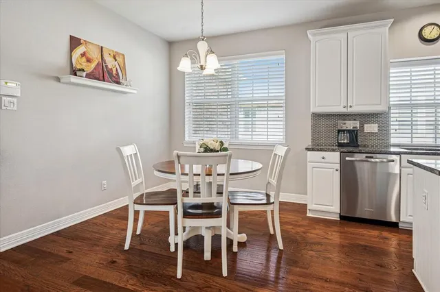 a dining room with wooden floor and breakfast area