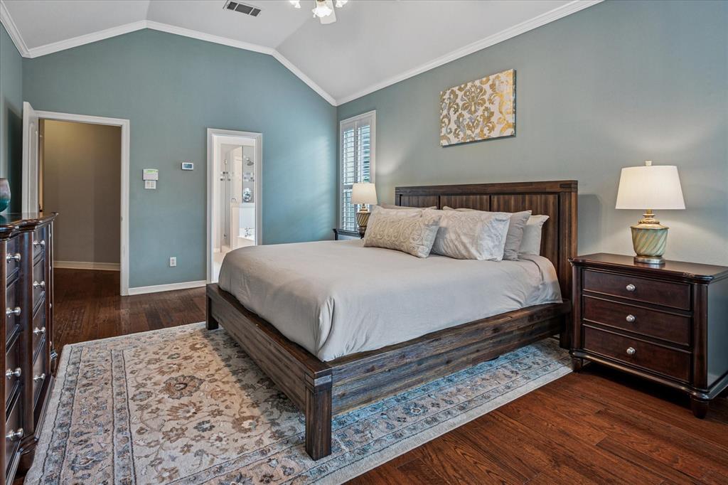 7509 Cedar Elm Drive Irving, TX 75063 - Photo 15 of 40 a bedroom with a bed and a lamp on dresser